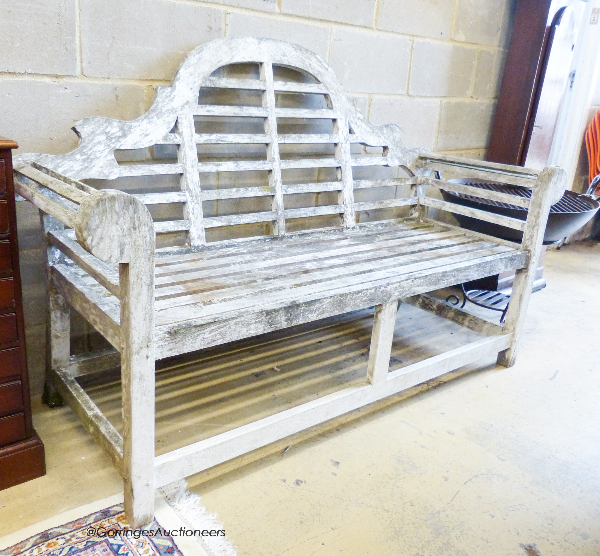 A weathered teak Lytchens style garden bench, length 160cm, depth 66cm, height 105cm